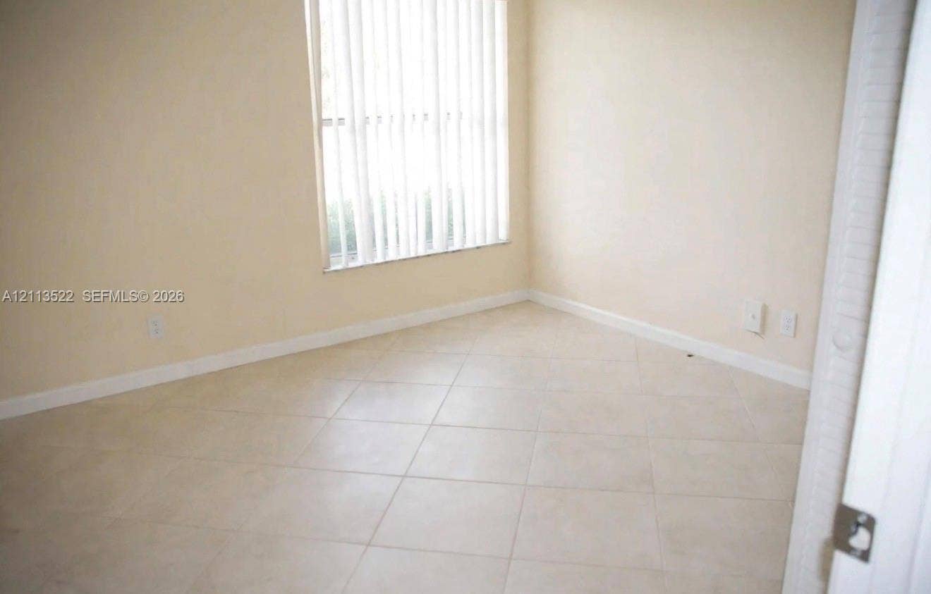405 S Pine Island Road, #105D, Plantation, Plantation, FL 33324 Neutral-toned ceramic tile flooring, vertical window blinds, and crisp off-white wall finishes