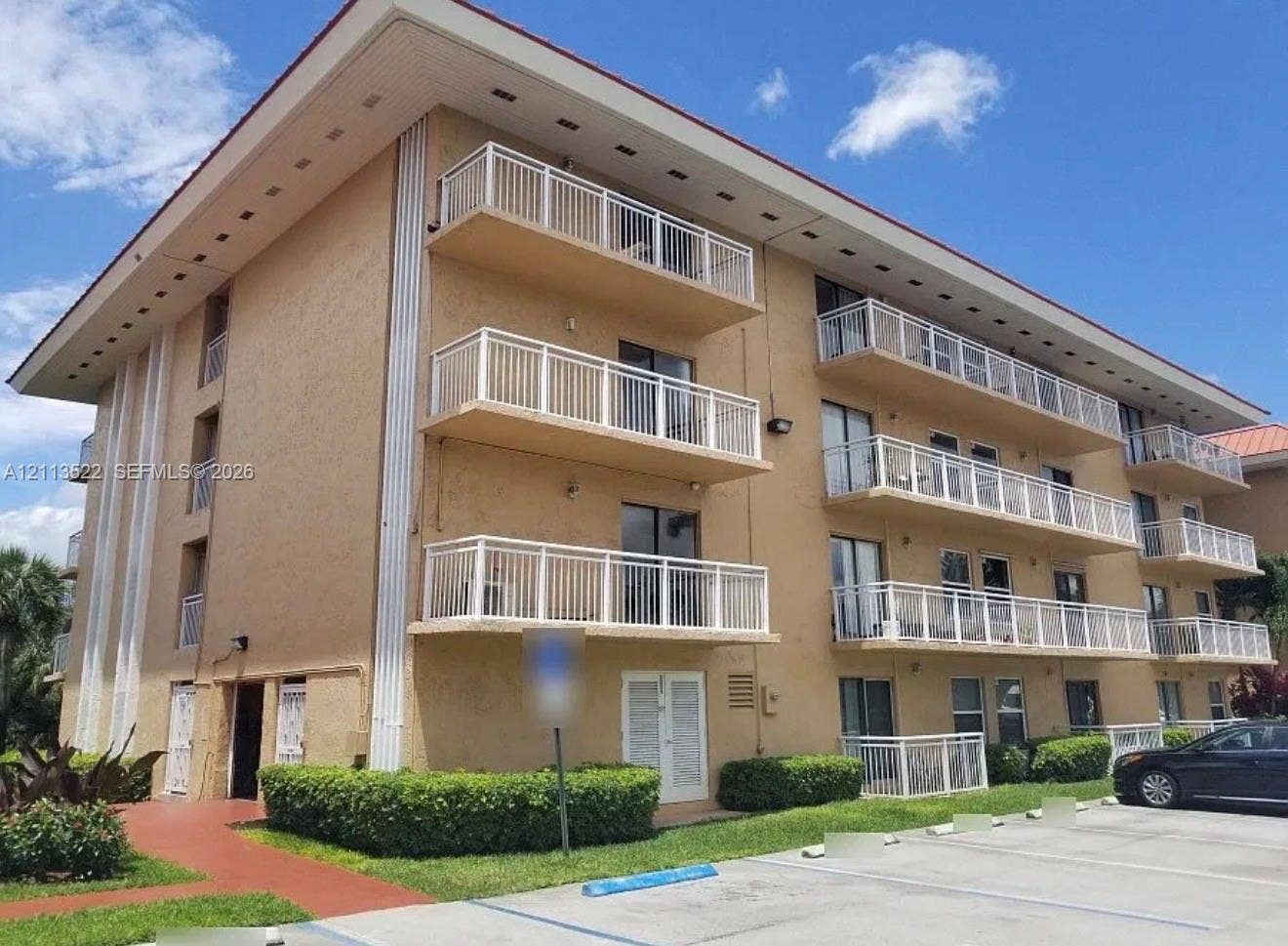 405 S Pine Island Road, #105D, Plantation, Plantation, FL 33324 Multi-story exterior featuring a textured facade, stacked balconies with white railings, and a wide roof overhang