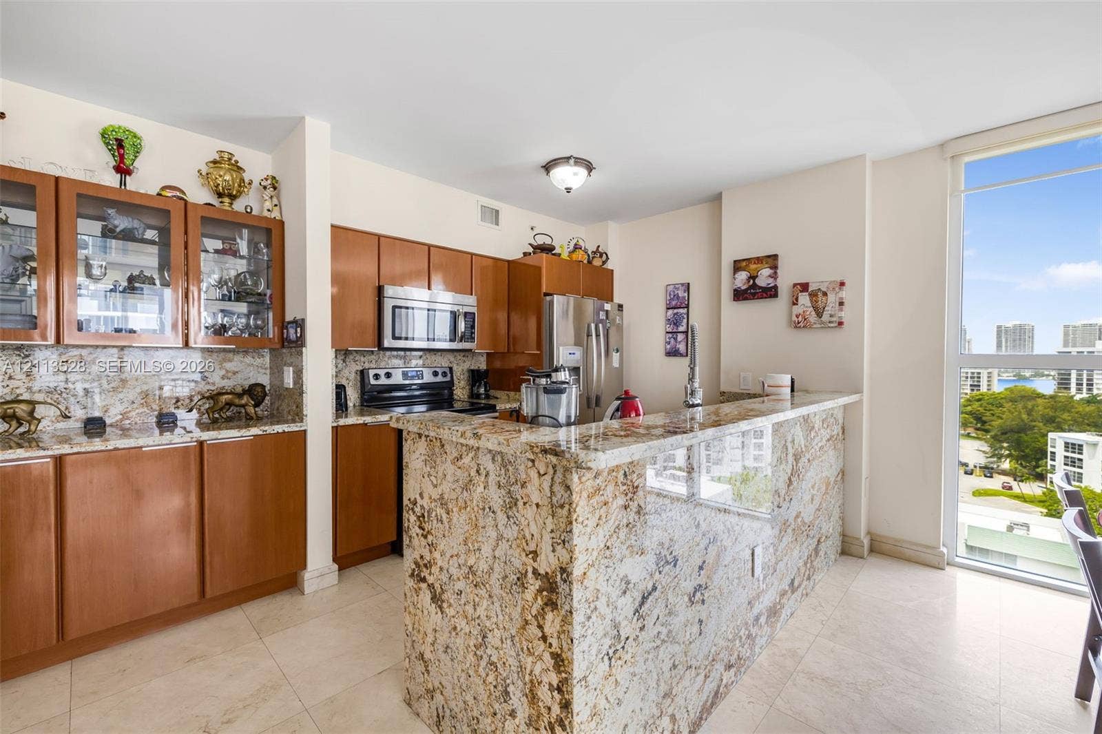 17555 Atlantic Boulevard, #1108, Sunny Isles Beach, Sunny Isles Beach, FL 33160 Kitchen featuring wood cabinetry, stone countertops, stone-finish backsplash, stainless steel appliances, and floor-to-ceiling windows