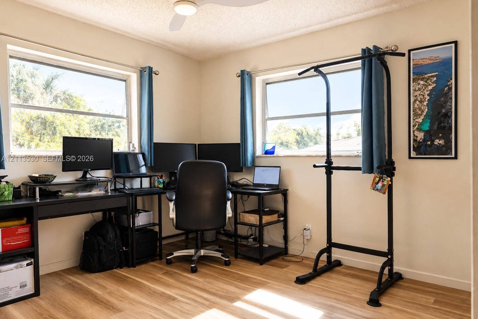 1773 NW 82nd Avenue, Coral Springs, FL 33071 Wood-finish flooring, two large windows providing natural light, and a ceiling-mounted light fixture