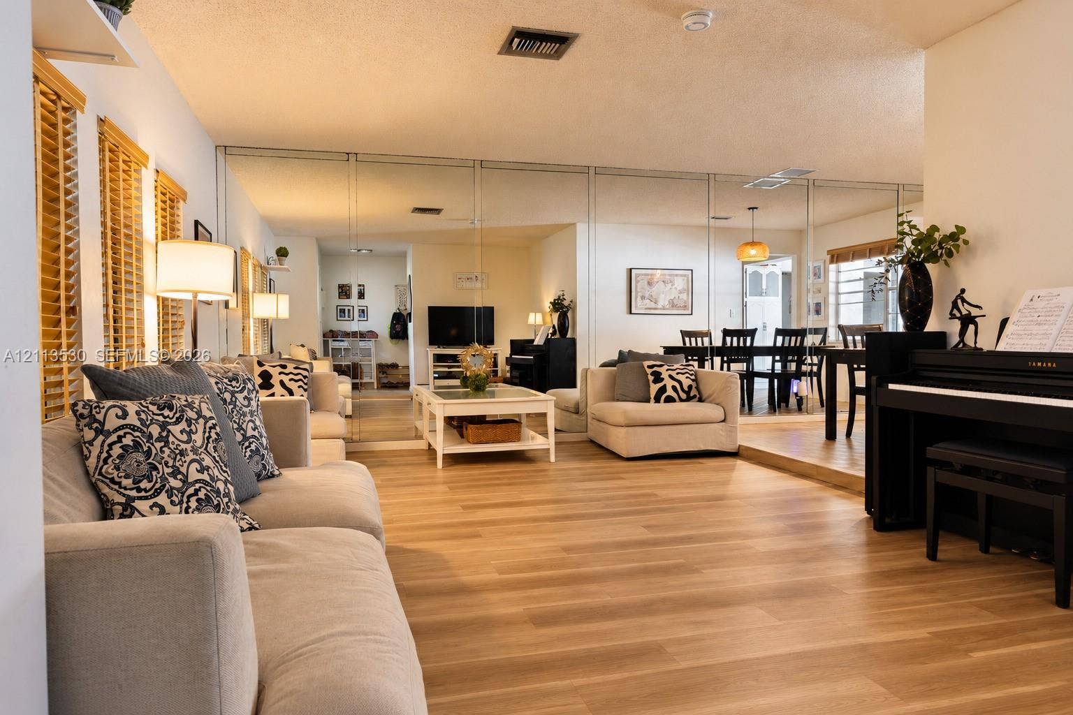 1773 NW 82nd Avenue, Coral Springs, FL 33071 Wood-finish flooring, full-wall mirrored paneling, and elevated platform area