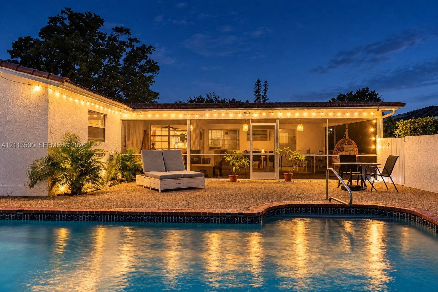 1773 NW 82nd Avenue, Coral Springs, FL 33071 Exterior swimming pool with brick coping, screened-in patio, and aggregate stone hardscaping