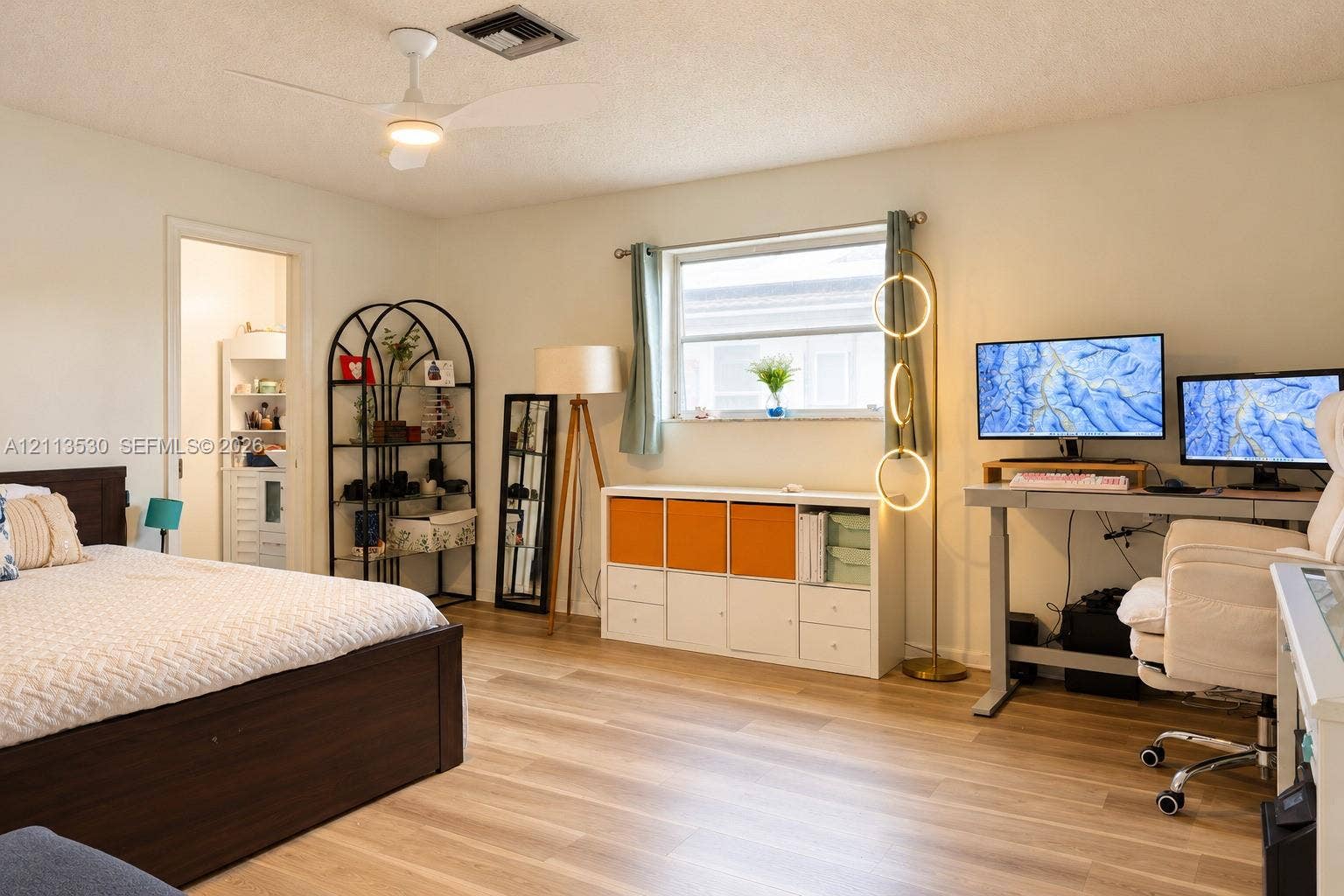 1773 NW 82nd Avenue, Coral Springs, FL 33071 Room featuring wood-finish flooring, a neutral color palette, a ceiling fan with integrated lighting, and a single-pane window