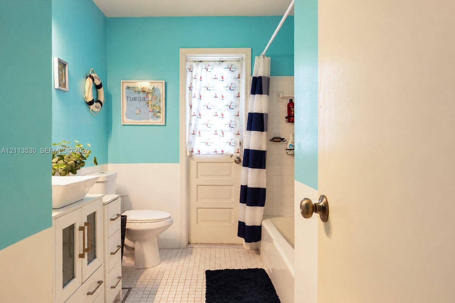 1773 NW 82nd Avenue, Coral Springs, FL 33071 White vanity featuring a rectangular vessel sink and brass-finish hardware, square tile flooring, and a tub-shower combination with white wall tile