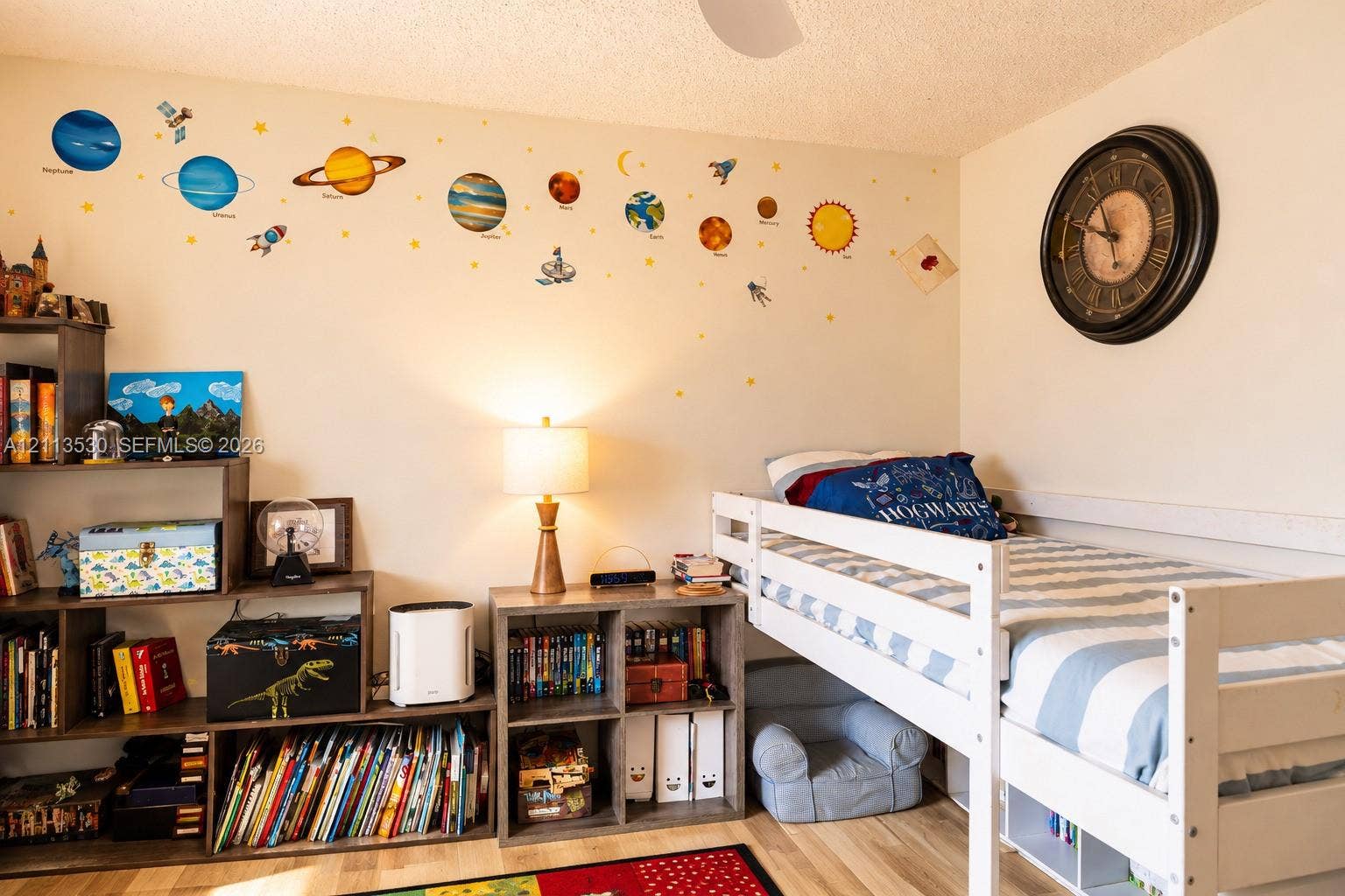 1773 NW 82nd Avenue, Coral Springs, FL 33071 Room featuring wood-finish flooring and a circular wall-mounted clock