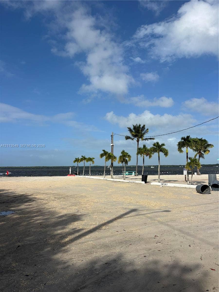 93 1st Court, Key Largo, FL 33037 Sandy waterfront area featuring palm trees and direct water access