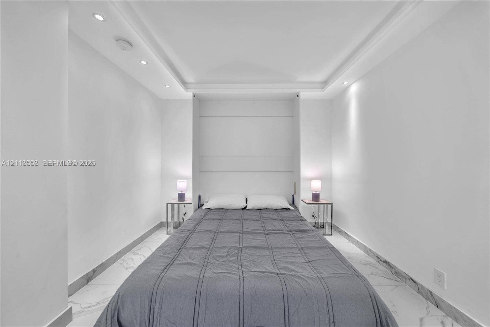400 S Pointe Drive, #2106, Miami Beach, FL 33139 Built-in wall cabinetry, recessed tray ceiling lighting, and polished stone-finish tile flooring
