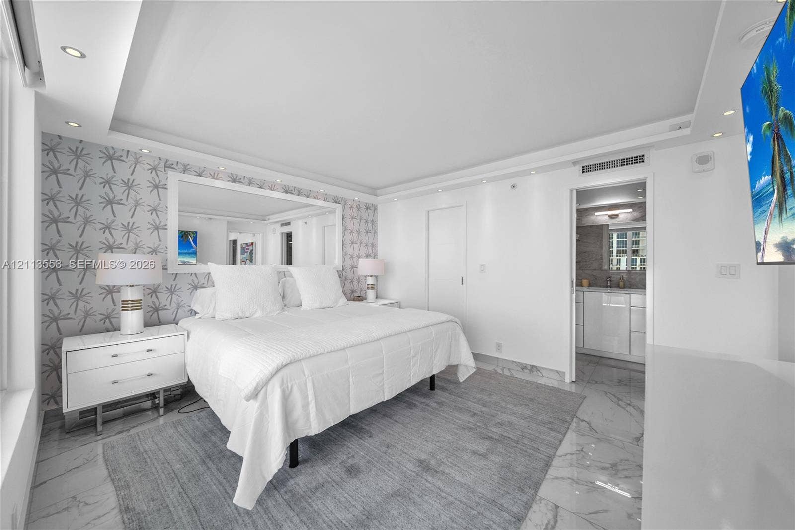 400 S Pointe Drive, #2106, Miami Beach, FL 33139 Room featuring large-format stone-finish tile flooring, recessed ceiling lighting, a framed wall mirror, and patterned wall covering