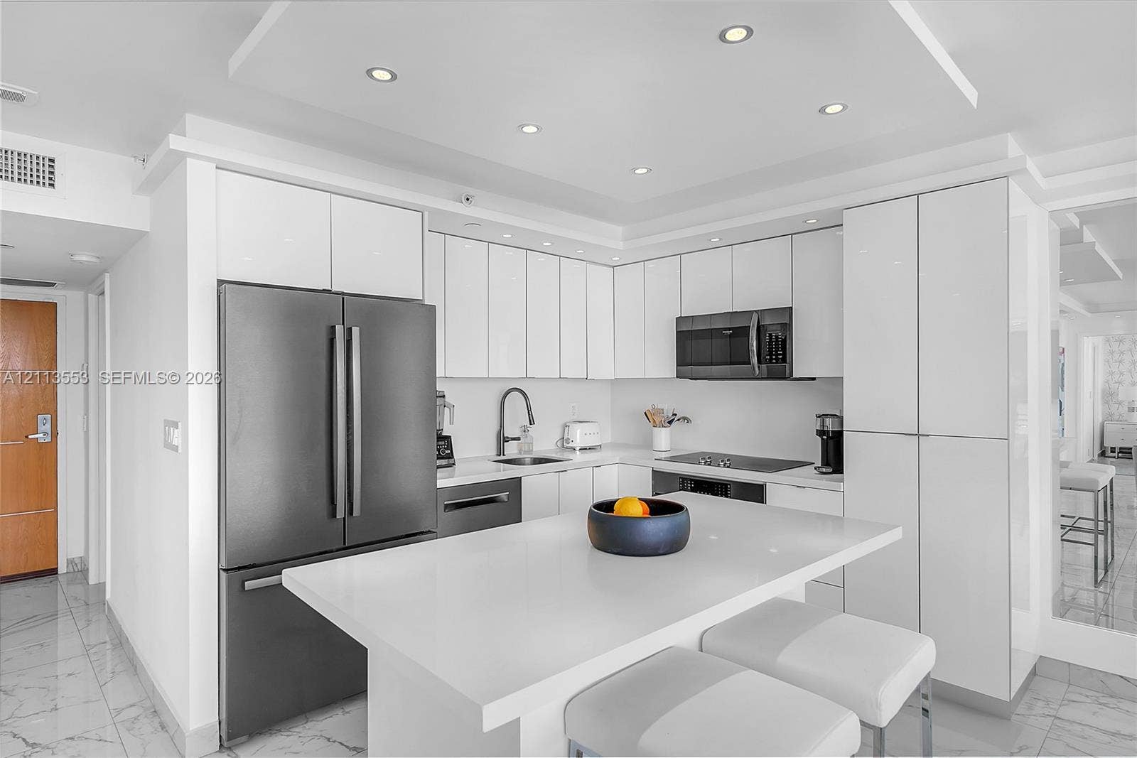 400 S Pointe Drive, #2106, Miami Beach, FL 33139 Kitchen featuring high-gloss white cabinetry, white stone countertops, an oversized center island, stainless steel appliances, and recessed ceiling lighting
