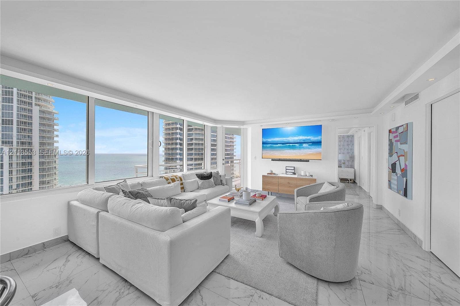 400 S Pointe Drive, #2106, Miami Beach, FL 33139 Floor-to-ceiling windows, stone-finish tile flooring, recessed lighting, and wall-mounted television console