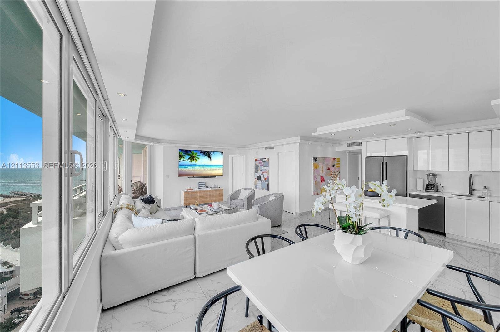 400 S Pointe Drive, #2106, Miami Beach, FL 33139 Open-concept interior featuring floor-to-ceiling windows, polished tile flooring, recessed lighting, and white gloss cabinetry