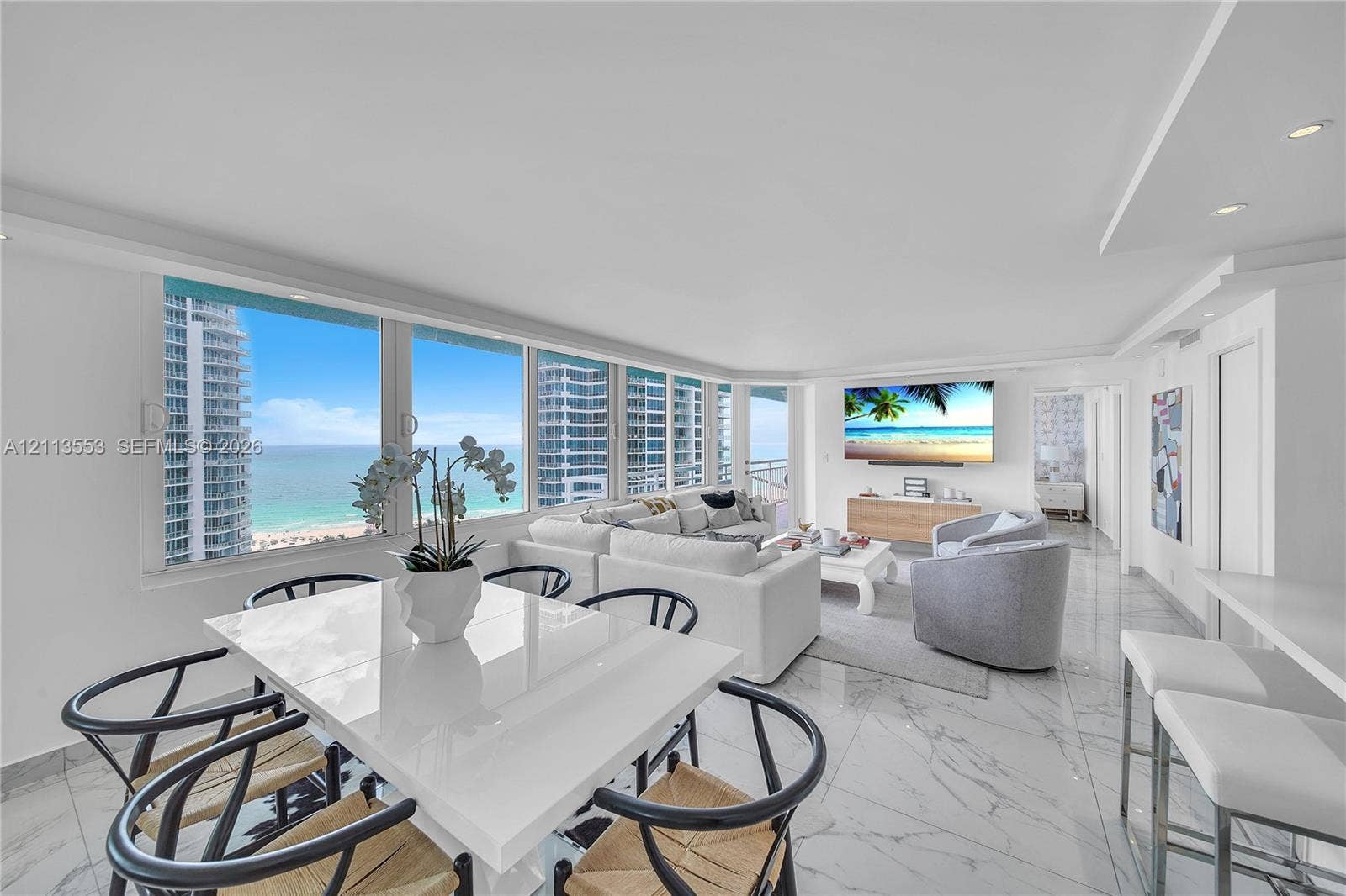400 S Pointe Drive, #2106, Miami Beach, FL 33139 Open-concept interior featuring floor-to-ceiling windows, natural stone-finish flooring, recessed lighting, and expansive ocean scenery