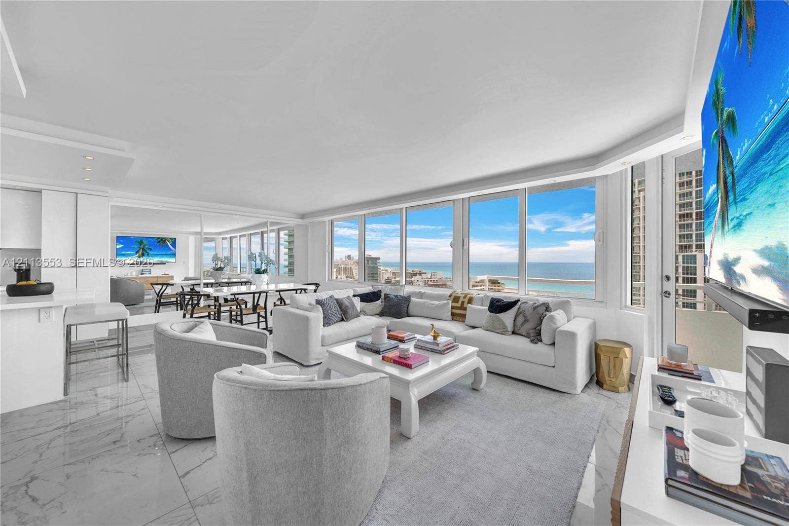 400 S Pointe Drive, #2106, Miami Beach, FL 33139 Open-concept living space featuring floor-to-ceiling windows, polished stone-finish flooring, recessed ceiling lighting, and a neutral color palette