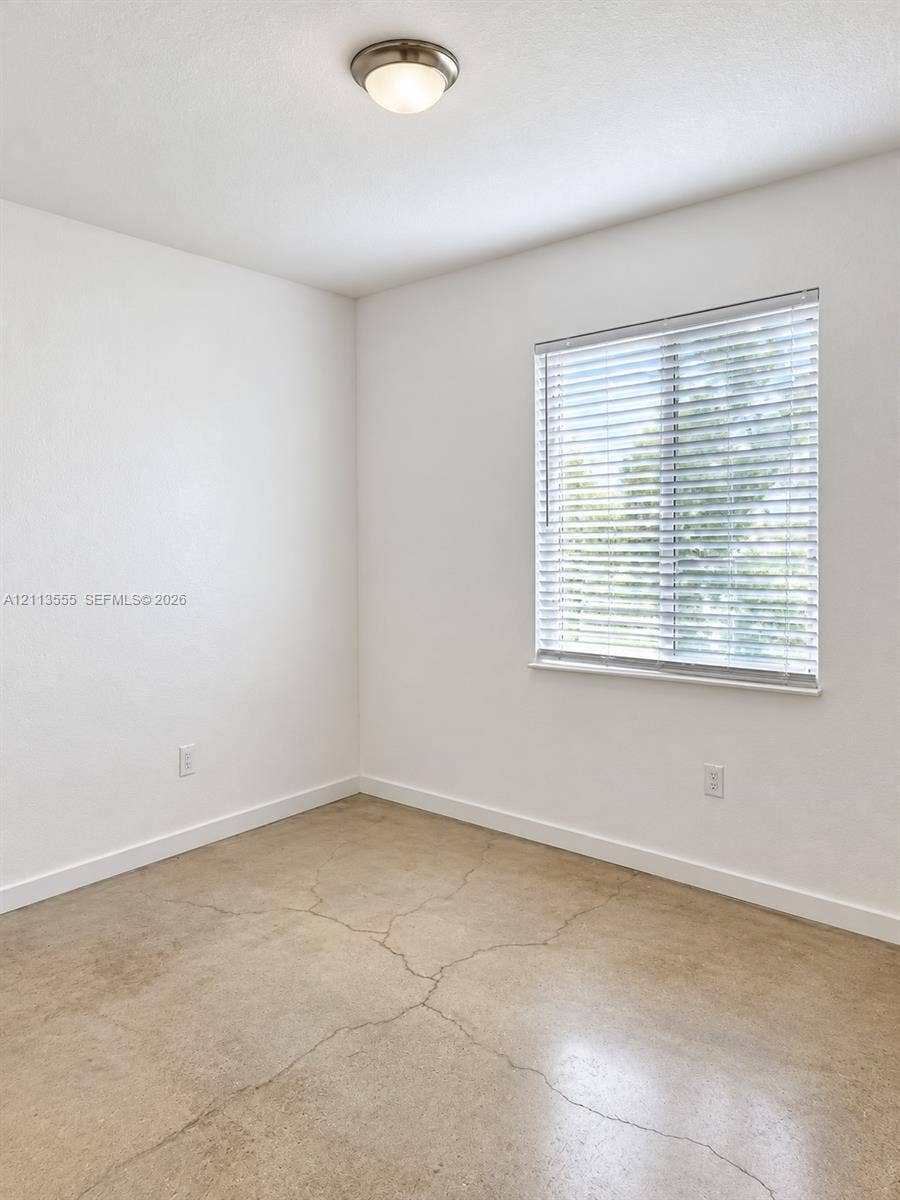 104 NW 31st Avenue, Fort Lauderdale, Fort Lauderdale, FL 33311 Polished concrete flooring, neutral wall finish, horizontal window blinds, and a semi-flush mount ceiling fixture