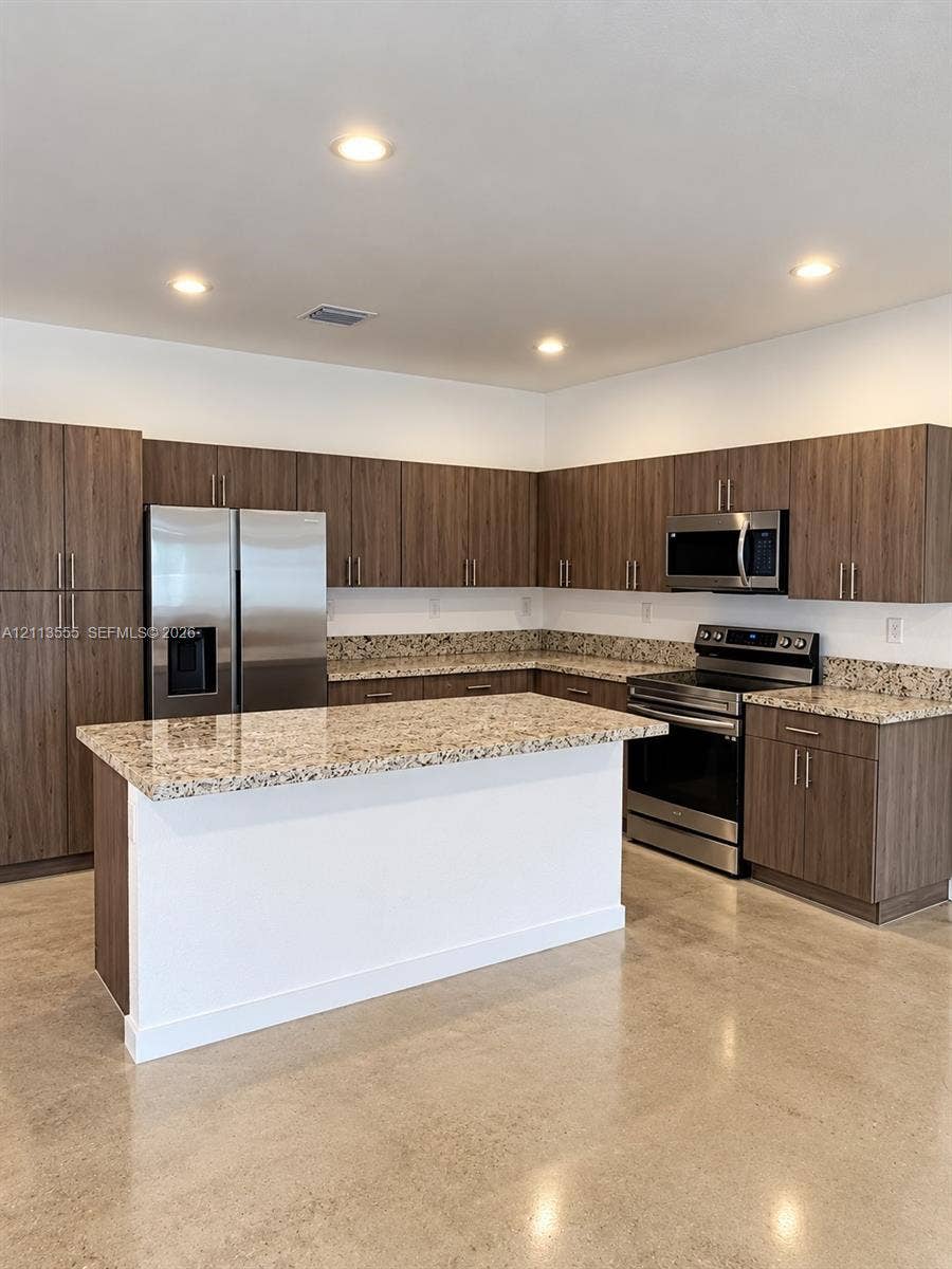 104 NW 31st Avenue, Fort Lauderdale, Fort Lauderdale, FL 33311 Kitchen featuring flat-panel wood-finish cabinetry, stone-surface countertops, a center island, polished concrete flooring, and stainless steel appliances