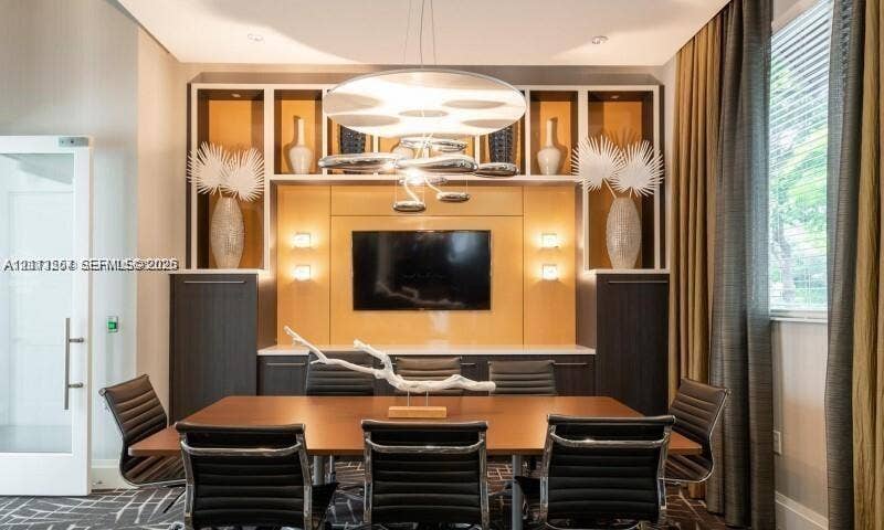320 Franklin Club Drive, #Boca 1, Delray Beach, Delray Beach, FL 33483 Custom floor-to-ceiling built-in cabinetry featuring integrated recessed lighting, high-contrast wood-grain finishes, and a contemporary multi-tiered overhead chandelier