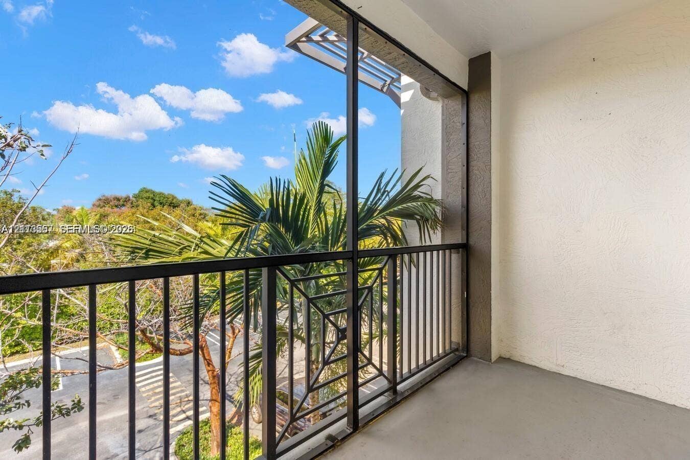320 Franklin Club Drive, #Boca 1, Delray Beach, Delray Beach, FL 33483 Covered balcony featuring a screened-in enclosure, metal railings with geometric detailing, and a smooth-finish concrete floor
