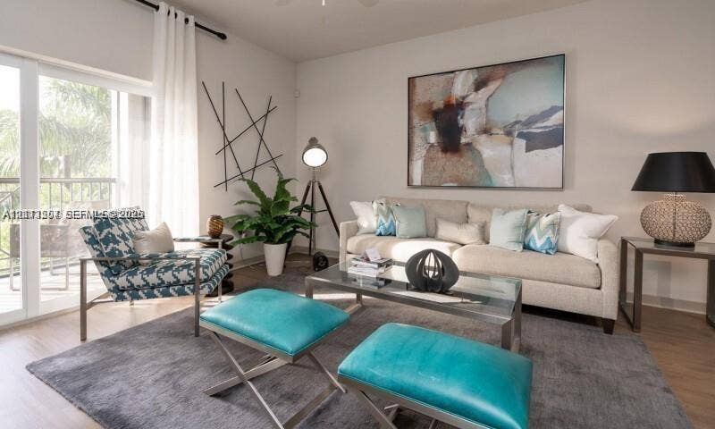 320 Franklin Club Drive, #Boca 1, Delray Beach, Delray Beach, FL 33483 Sliding glass door with access to a balcony, neutral wall tones, and wood-finish flooring