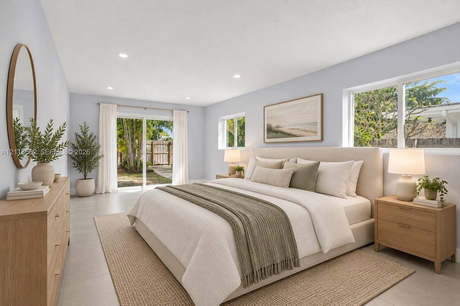 Neutral-toned interior featuring large-format tile flooring, recessed lighting, and sliding glass doors