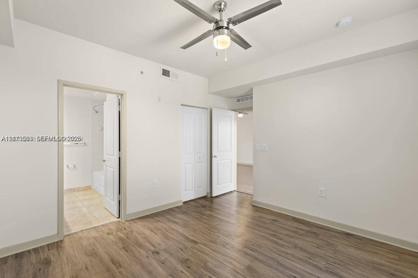320 Franklin Club Drive, #Boynton, Delray Beach, Delray Beach, FL 33483 Room featuring wood-finish flooring, a ceiling fan with integrated lighting, and multiple interior doors