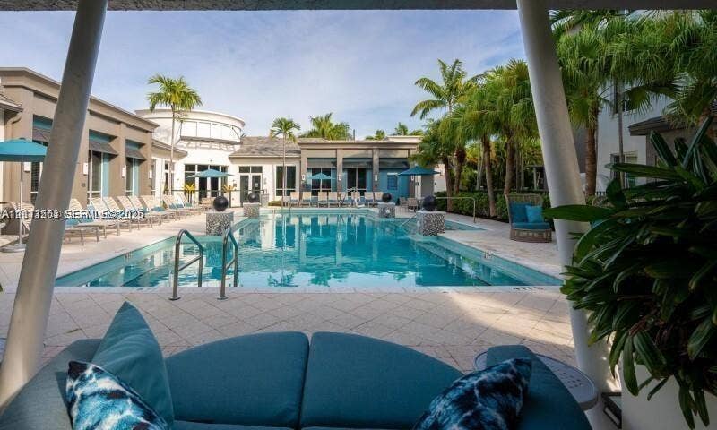 320 Franklin Club Drive, #Boynton, Delray Beach, Delray Beach, FL 33483 Swimming pool with tiled decking, structural columns, and surrounding palm trees