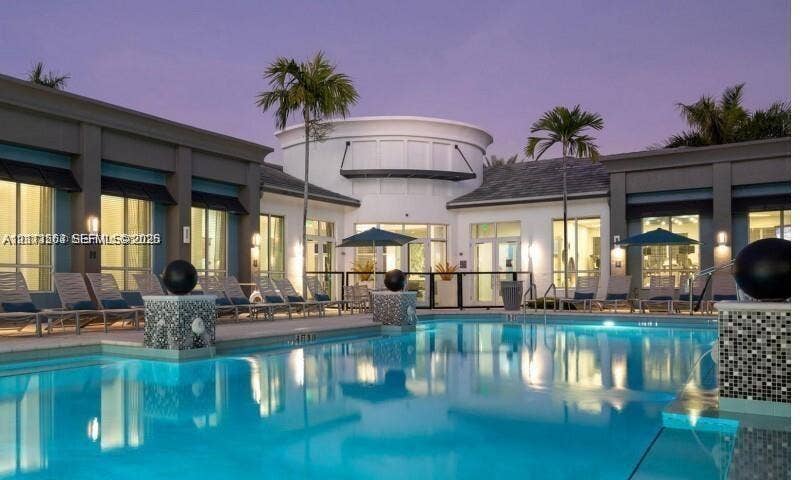 320 Franklin Club Drive, #Boynton, Delray Beach, Delray Beach, FL 33483 Swimming pool featuring decorative mosaic tile pillars, expansive paved patio, and multi-pane glass doors