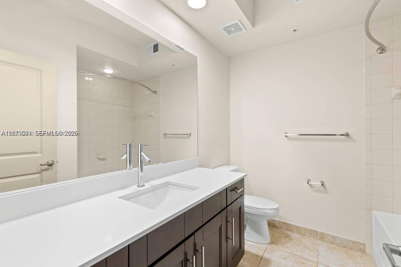 320 Franklin Club Drive, #Boynton, Delray Beach, Delray Beach, FL 33483 Bathroom featuring a dark-finish wood vanity, white countertop with an integrated rectangular basin, single-lever polished chrome faucet, full-width wall mirror, and tile flooring