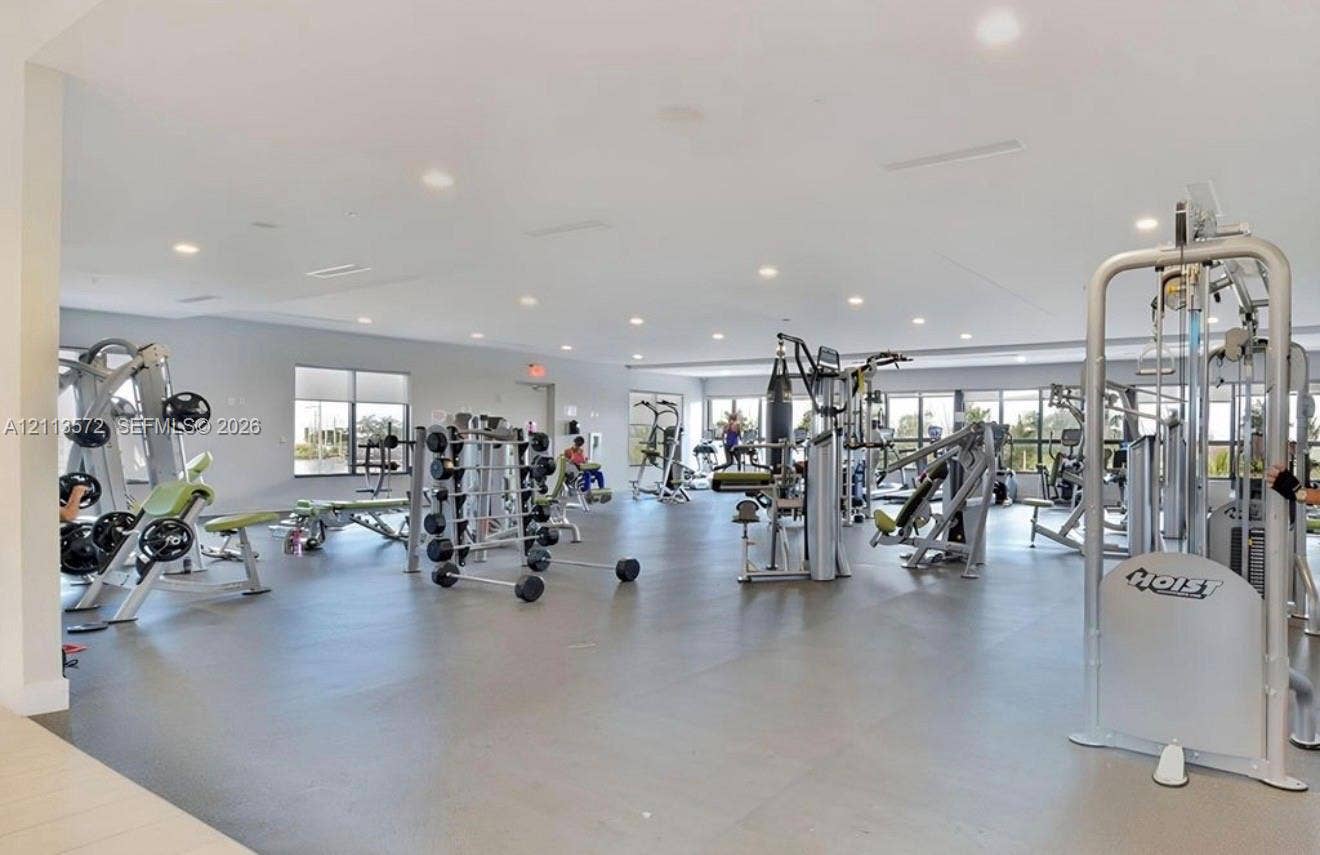 9860 NW 86th Terrace, Doral, FL 33178 Expansive fitness center featuring recessed lighting, rubberized flooring, and numerous large windows