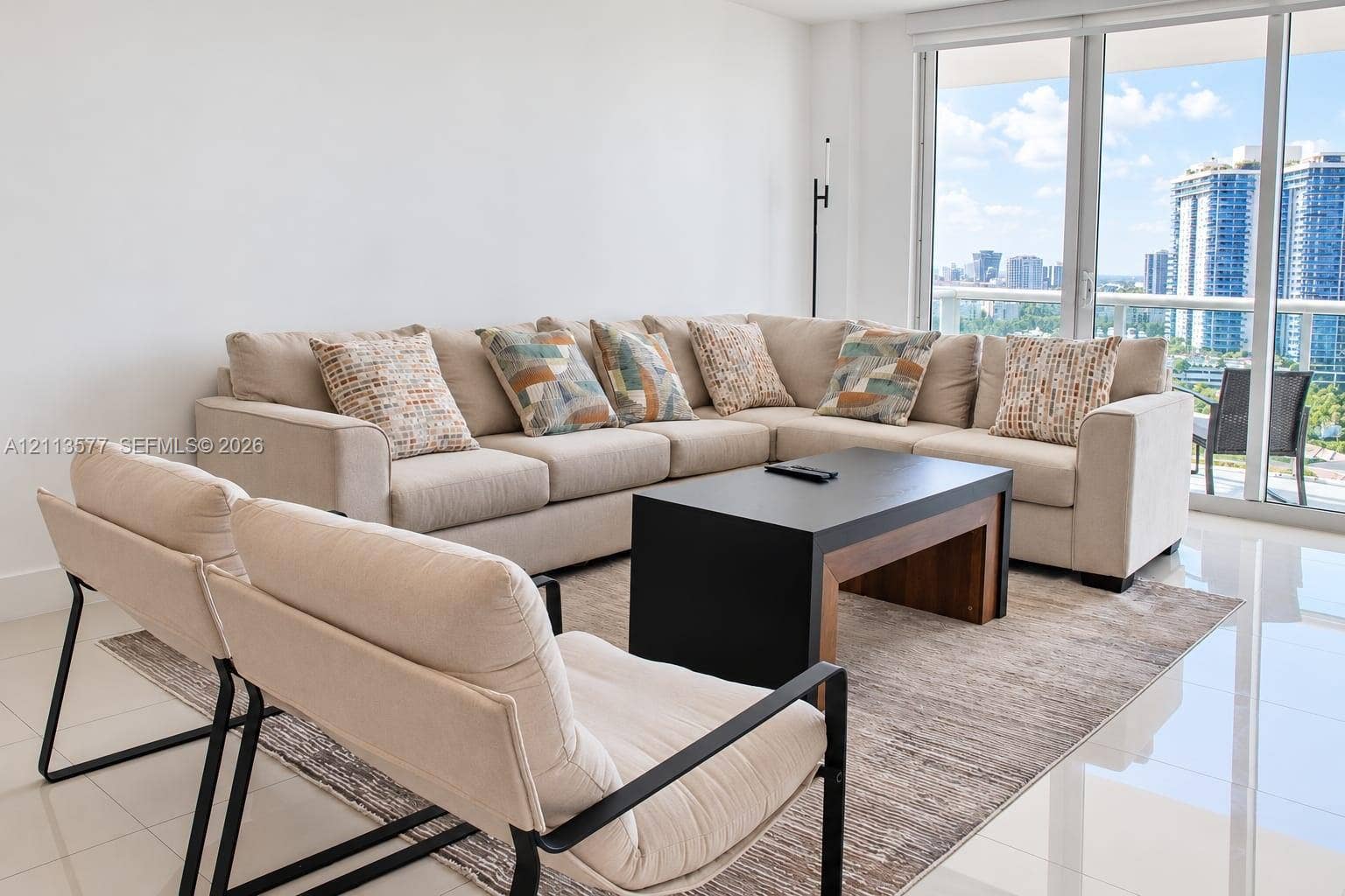 19370 Collins Avenue, #1622, Sunny Isles Beach, FL 33160 Floor-to-ceiling glass panel windows, polished tile flooring, and a glass-railed balcony