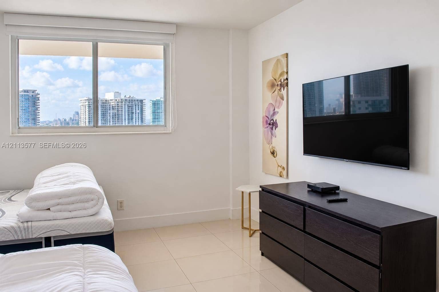 19370 Collins Avenue, #1622, Sunny Isles Beach, FL 33160 Large-format tile flooring, expansive window with city skyline, and neutral wall finishes