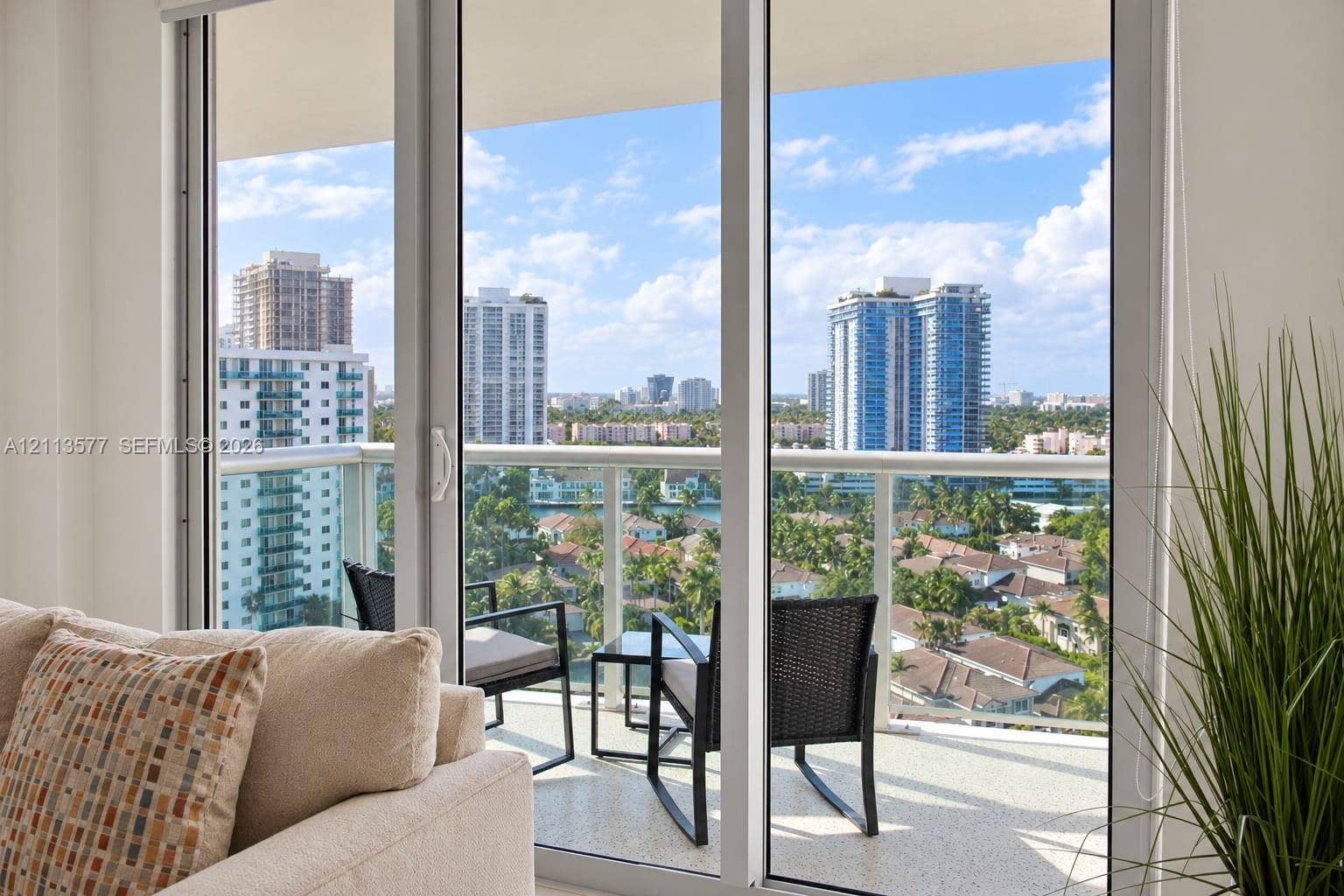 19370 Collins Avenue, #1622, Sunny Isles Beach, FL 33160 Full-height sliding glass doors with white framing and a private balcony featuring a glass-panel railing