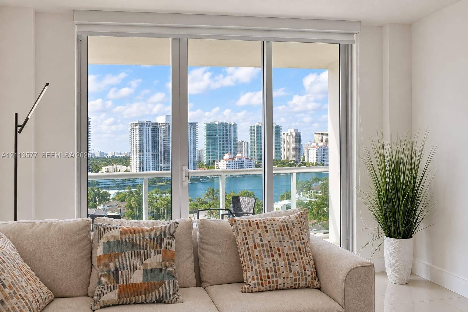 19370 Collins Avenue, #1622, Sunny Isles Beach, FL 33160 Floor-to-ceiling glass panel windows, glass-railing balcony, and expansive urban waterfront skyline scenery