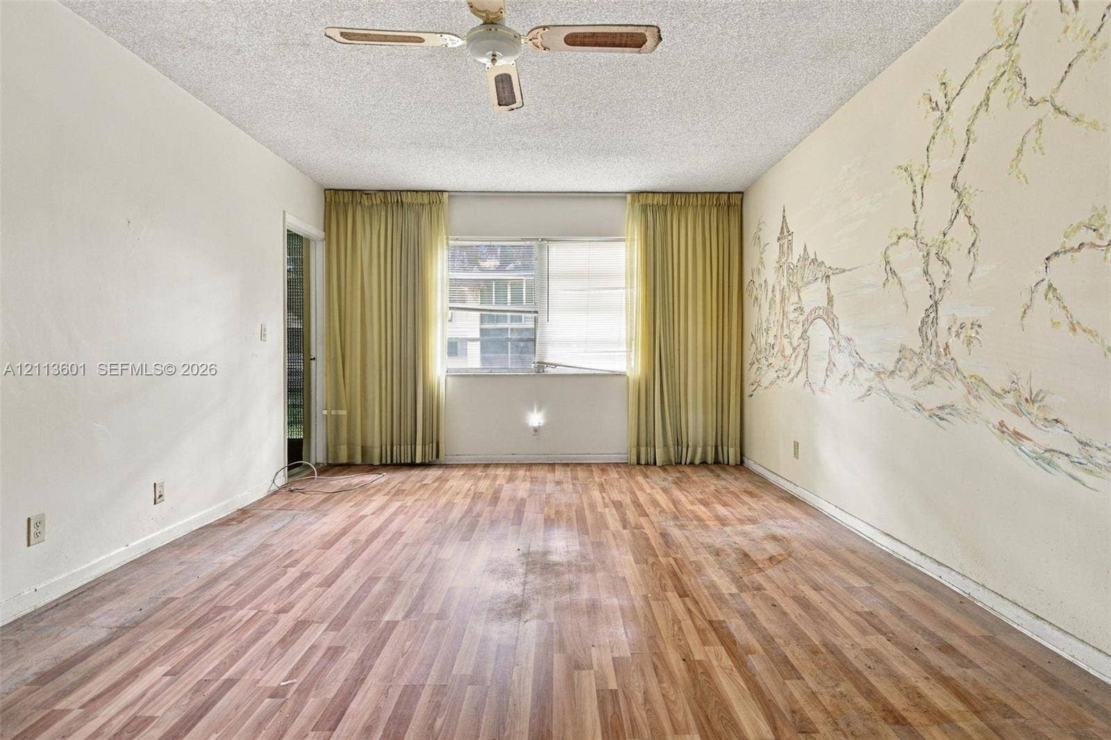Wood-finish flooring, ceiling-mounted fan, and wall mural