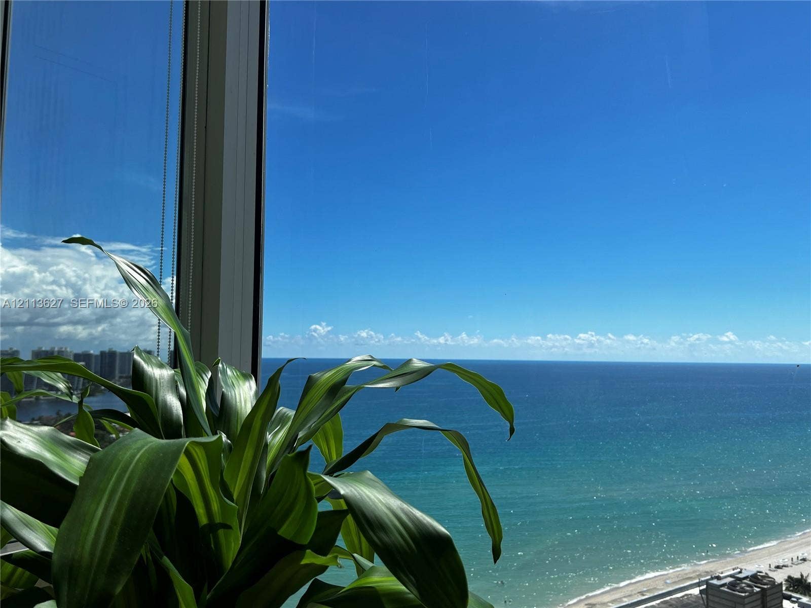 Floor-to-ceiling windows featuring panoramic ocean and coastline exposure