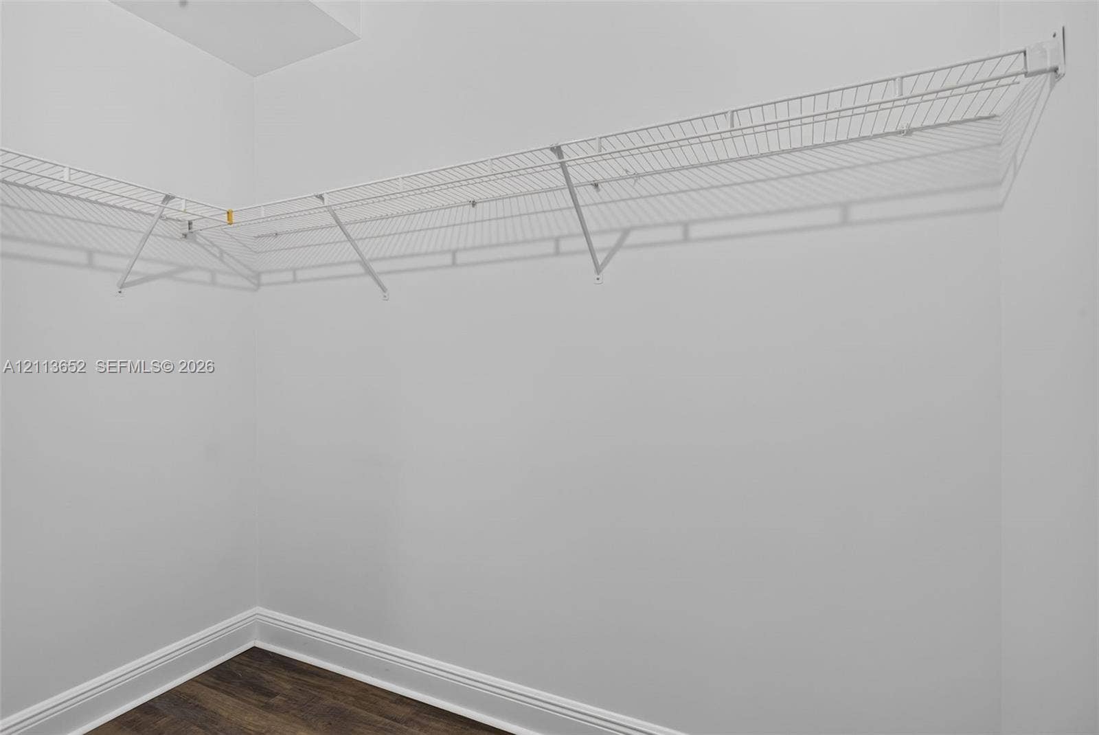 618 SW 1st Lane, Pompano Beach, FL 33060 White wire-mesh shelving unit with wall-mounted brackets and wood-finish flooring