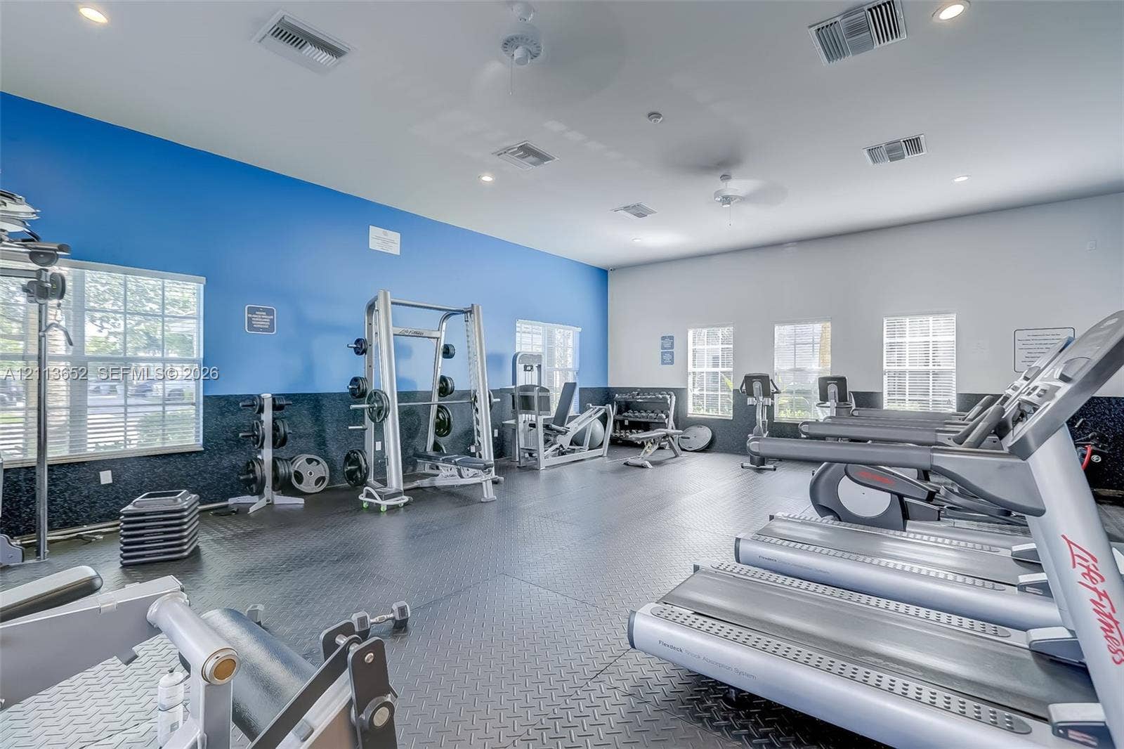 618 SW 1st Lane, Pompano Beach, FL 33060 Fitness center featuring rubber flooring, recessed lighting, and multiple windows