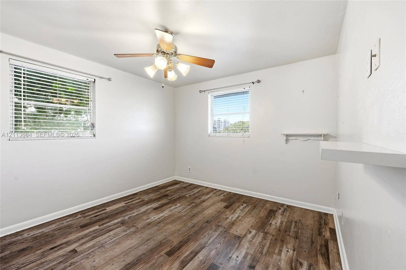 6504 Lenore Drive, Tampa, Tampa, FL 33634 Wood-finish flooring, dual windows with blinds, and ceiling fan with integrated lighting