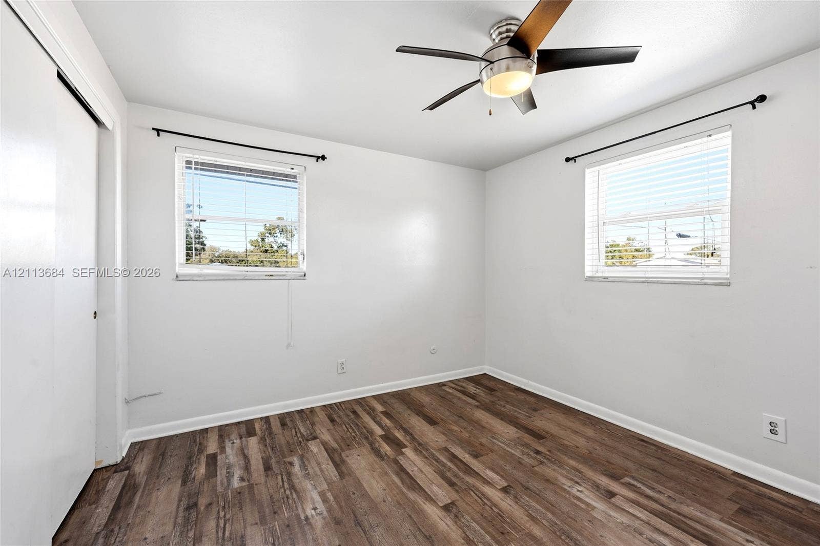 6504 Lenore Drive, Tampa, Tampa, FL 33634 Wood-finish flooring, dual windows with mounted hardware, and a ceiling fan with integrated lighting
