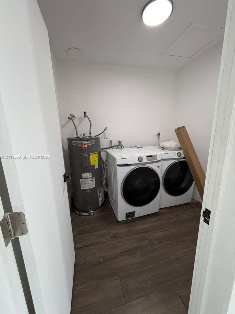 115 NE 205th Terrace, Miami Gardens, FL 33179 Laundry area featuring wood-finish flooring, ceiling-mounted lighting, and an upright electric water heater