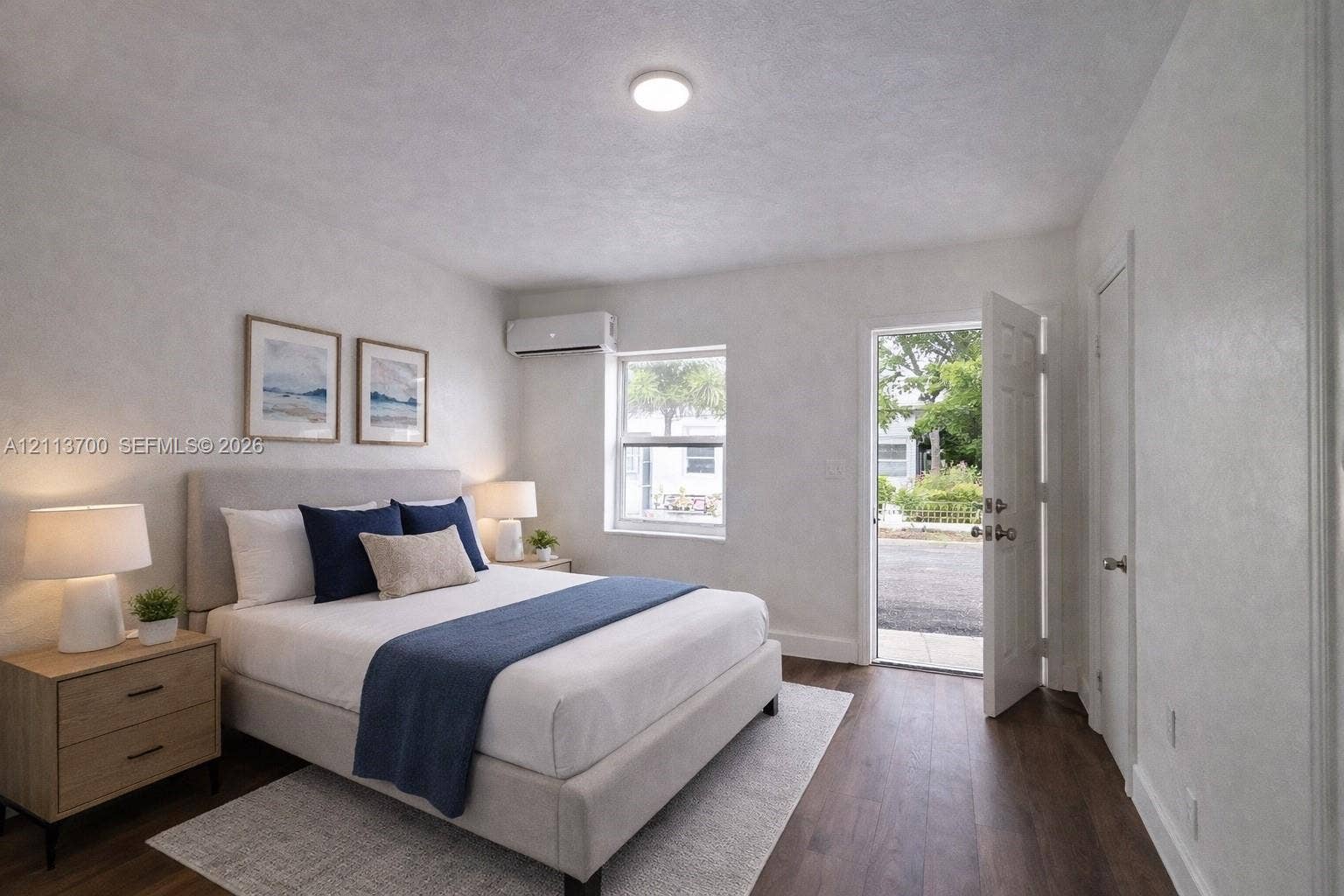 2707 Lincoln Street, #17-18, Hollywood, Hollywood, FL 33020 Wood-finish flooring, wall-mounted ductless climate control unit, single-hung window, and swinging exterior entry door