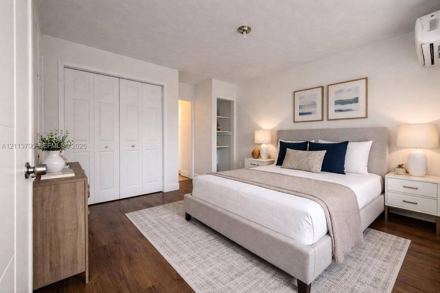 2707 Lincoln Street, #17-18, Hollywood, Hollywood, FL 33020 Wood-finish flooring, double-door closet with recessed paneling, built-in open shelving, and wall-mounted climate control unit