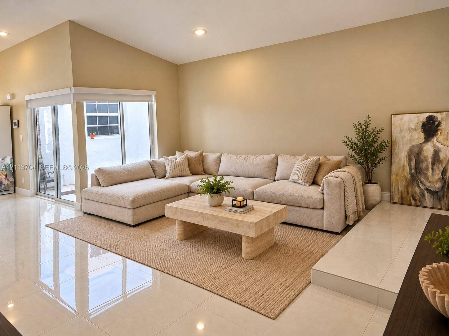 5254 SW 153rd Court, Miami, FL 33185 Living area featuring large-format tile flooring, recessed lighting, elevated platform section, and sliding glass doors