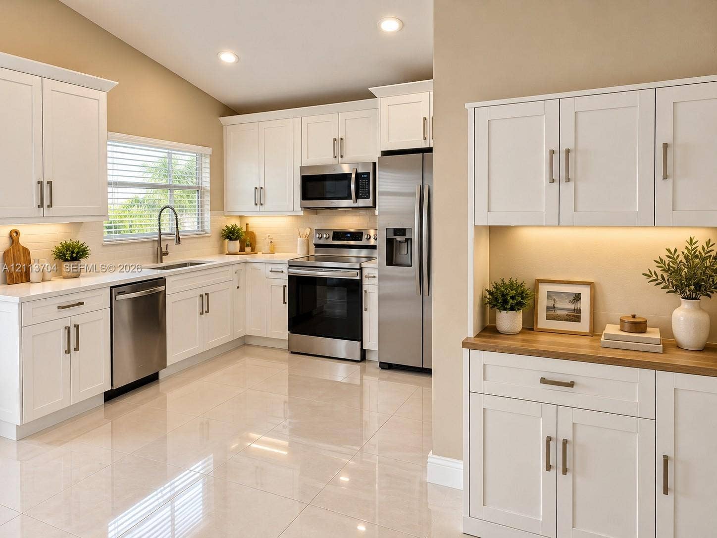 5254 SW 153rd Court, Miami, FL 33185 Kitchen featuring white shaker-style cabinetry, stainless steel appliances, polished tile flooring, under-cabinet lighting, and a wood-finish countertop