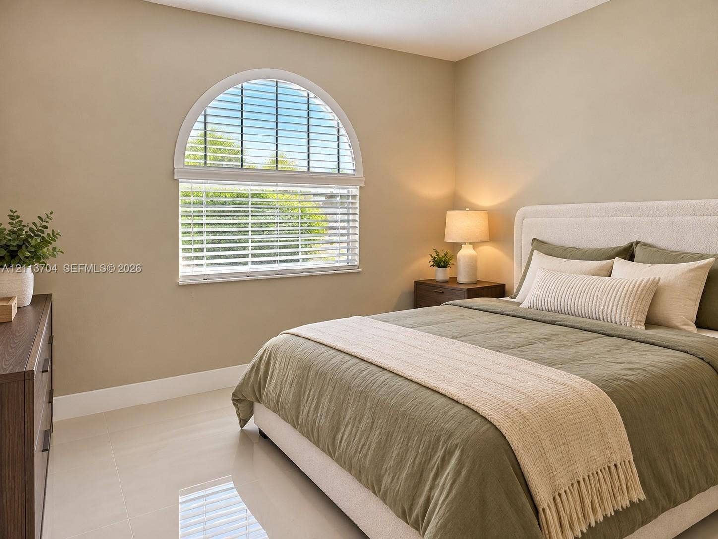 5254 SW 153rd Court, Miami, FL 33185 Room featuring neutral wall paint, polished tile flooring, and an arched window with horizontal blinds