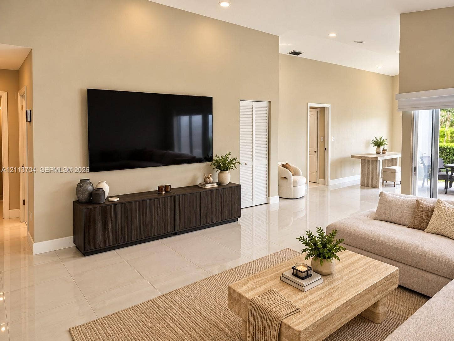 5254 SW 153rd Court, Miami, FL 33185 High-ceiling living area featuring large-format tile flooring, recessed lighting, and sliding glass doors