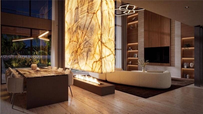 3322 NE 16th Court, Fort Lauderdale, FL 33305 Double-height ceiling, floor-to-ceiling backlit stone feature wall, linear gas fireplace, custom built-in wood shelving, and wood-finish tile flooring