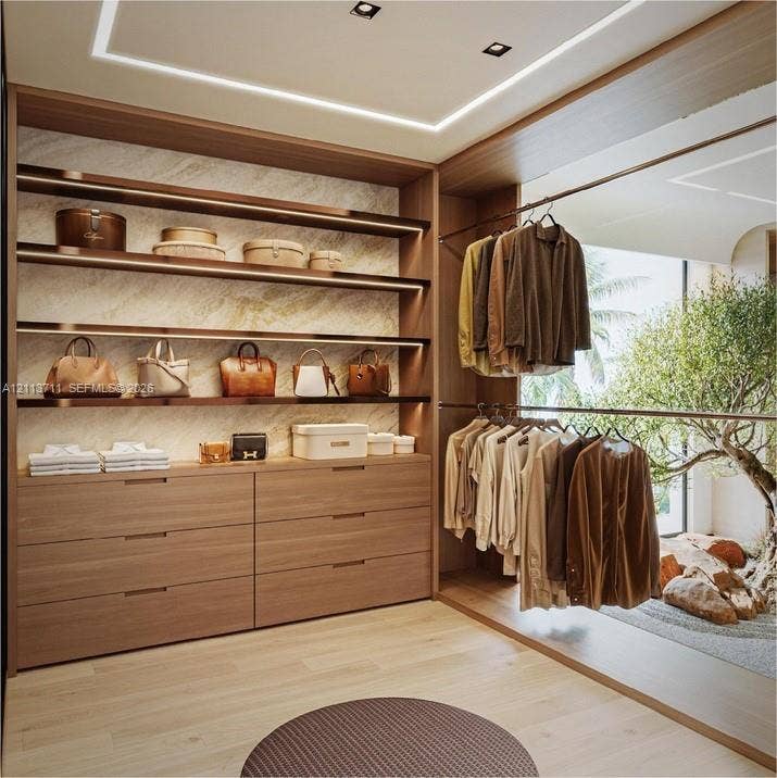 3322 NE 16th Court, Fort Lauderdale, FL 33305 Custom built-in wood-finish cabinetry, integrated linear LED shelving, recessed ceiling lighting, and polished stone wall accents