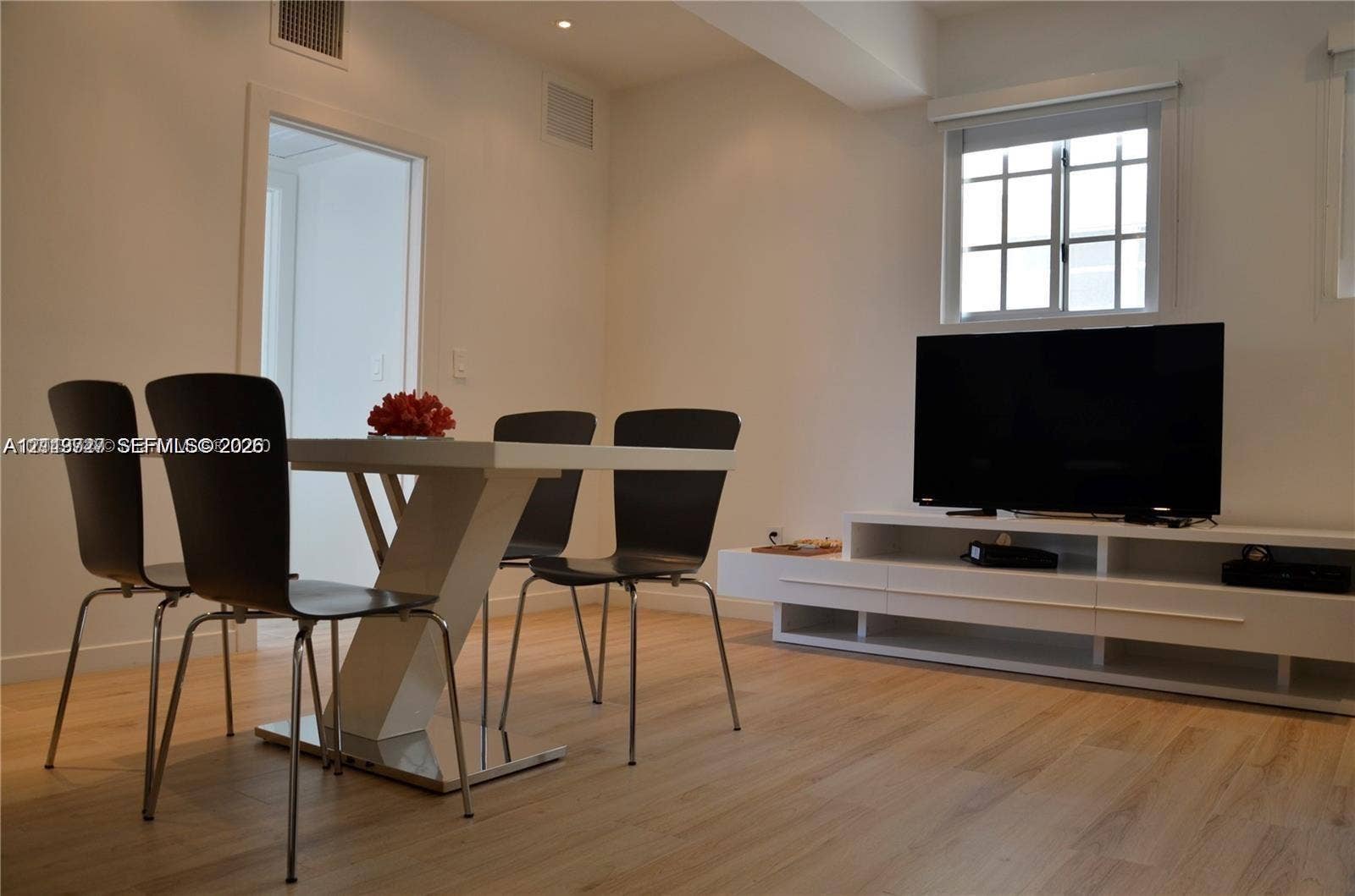 700 SE 16th Street, #201, Miami Beach, Miami Beach, FL 33139 Interior space featuring wood-finish flooring, recessed ceiling lighting, a multi-pane window, and a built-in floating media console