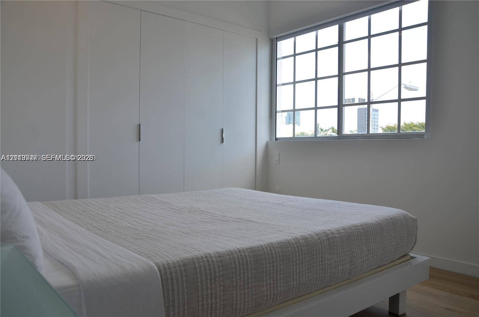 700 SE 16th Street, #201, Miami Beach, Miami Beach, FL 33139 Wall-to-wall built-in closet with clean-lined doors, grid-pattern window, and neutral interior finish