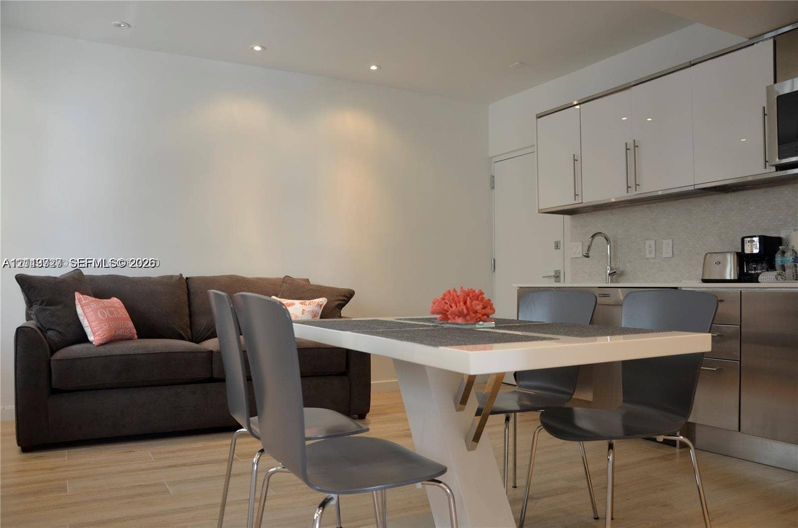 700 SE 16th Street, #201, Miami Beach, Miami Beach, FL 33139 Kitchen area featuring high-gloss cabinetry, stainless steel lower cabinets, recessed lighting, and wood-finish flooring